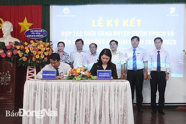 Chủ tịch UBND huyện Nguyễn Thị Giang Hương và Trưởng đại diện VNPT Đồng Nai Phạm Hùng Đức thực hiện ký kết hợp tác dưới sự chứng kiến của các đại biểu