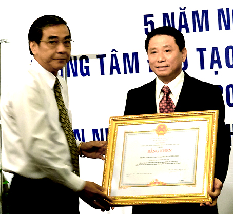 Ông Trần Văn Tư, Chủ tịch HĐND tỉnh trao bằng khen của Thủ tướng Chính phủ cho Giám đốc Trung tâm đào tạo và sát hạch lái xe tỉnh.