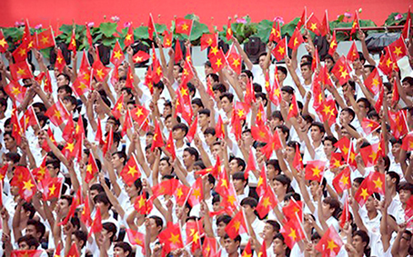 Vẫy cờ đỏ chào mừng đoàn diễu binh tại lễ kỷ niệm 40 năm thống nhất đất nước. (Ảnh minh họa) Ảnh: Quang Trung