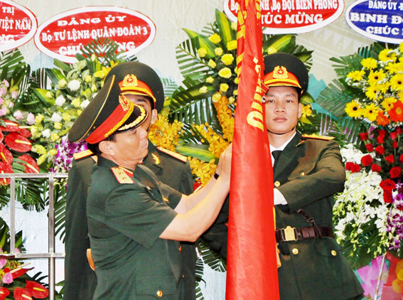 Trung tướng Phạm Hồng Hương, Phó Tổng tham mưu trưởng QĐND Việt Nam gắn huân chương bảo vệ Tổ quốc hạng nhất lên quân kỳ của nhà trường