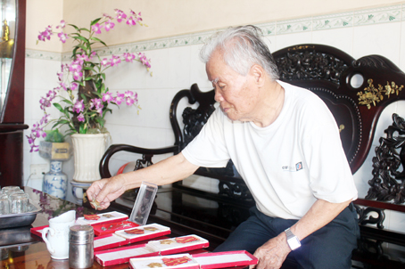 Ông Nguyễn Văn Be (xã Hưng Thịnh, huyện Trảng Bom) xem lại những tấm huân, huy chương của mình sau nhiều năm tham gia kháng chiến.