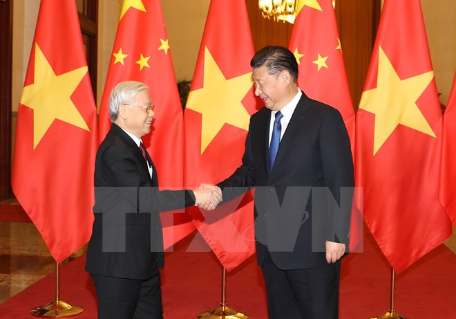 Tổng Bí thư, Chủ tịch nước Trung Quốc Tập Cận Bình đón Tổng Bí thư Nguyễn Phú Trọng. (Ảnh: Trí Dũng/TTXVN)