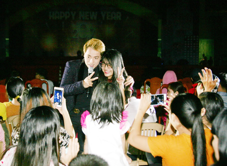 Nam ca sĩ Đăng Khôi (trái) hát và giao lưu với khán giả trong một buổi biểu diễn tại Đồng Nai.