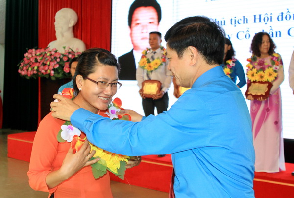Ông Bùi Văn Cường, Chủ tịch Tổng Liên đoàn Lao động Việt Nam trao hoa chúc mừng các công nhân được nhận danh hiệu Công nhân cao su Việt Nam ưu tú