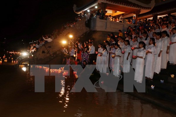 Đông đảo các tầng lớp nhân dân tham gia thả hoa đăng bên bờ Nam sông Thạch Hãn tưởng niệm các Anh hùng Liệt sỹ. (Ảnh: Quang Quyết/TTXVN)