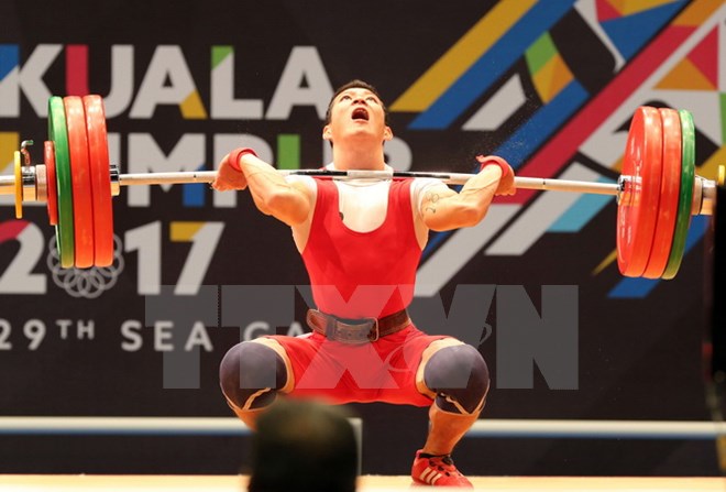 VĐV Thạch Kim Tuấn thi đấu chung kết nội dung Cử tạ hạng 56 kg nam. (Ảnh: Quốc Khánh/TTXVN)