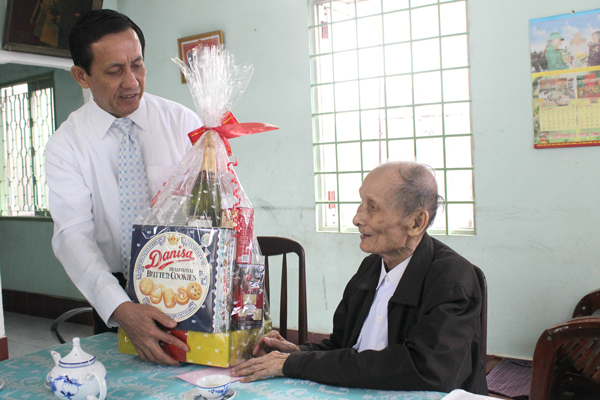 Đồng chí Phạm Văn Ru, Ủy viên Ban TVTU, Trưởng Ban Tổ chức Tỉnh ủy trao quà Tết cho đảng viên 70 tuổi Đảng Lê Thượng Đỉnh.