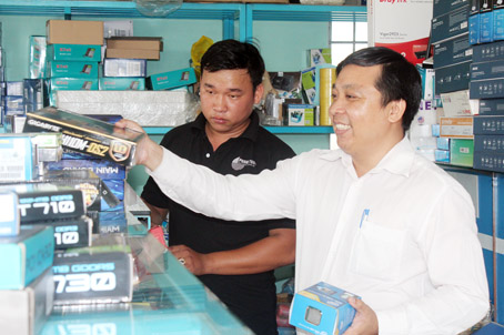 Anh Phạm Anh Tuấn (phải) trao đổi với nhân viên về một thiết bị mới. Ảnh: C. Tú