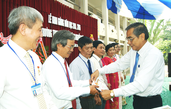 Phó bí thư thường trực Tỉnh ủy Trần Văn Tư trao thưởng cho các tập thể, cá nhân của Trường THPT Nguyễn Trãi nhân dịp khai giảng năm học 2015-2016. Ảnh: Tư liệu