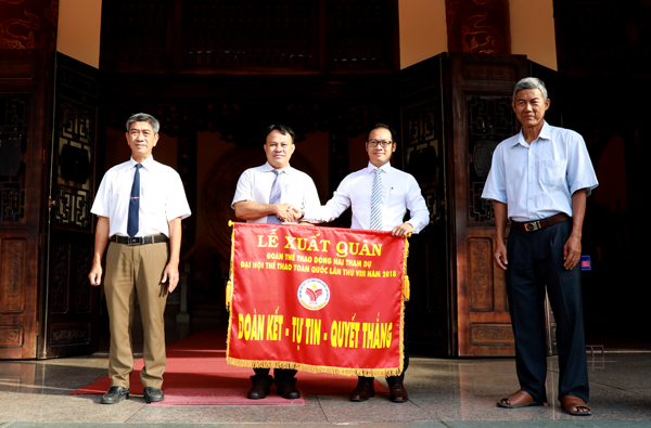 Phó giám đốc Sở Văn hóa, thể thao và du lịch Nguyễn Xuân Thanh (thứ hai từ phải qua) trao cờ xuất quân cho đại diện đoàn thể thao Đồng Nai.