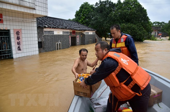 Lực lượng cứu hộ phân phát hàng hóa cứu trợ cho người dân vùng ngập lụt sau bão Mangkhut ở thành phố Dương Xuân, tỉnh Quảng Đông, miền nam Trung Quốc ngày 17-9-2018. (Nguồn: THX/TTXVN)