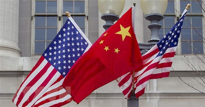 Quốc kỳ Trung Quốc (giữa) và quốc kỳ Mỹ. (Ảnh: Getty Images/ TTXVN)