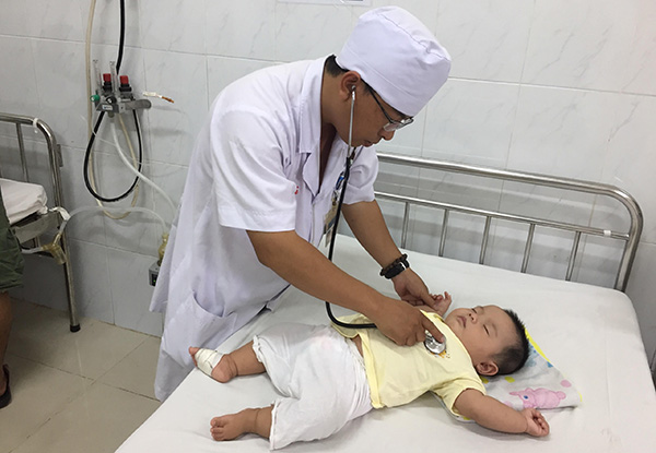 Bác sĩ Bệnh viện nhi đồng Đồng Nai thăm khám cho trẻ bị bệnh hô hấp. ảnh: H.Dung
