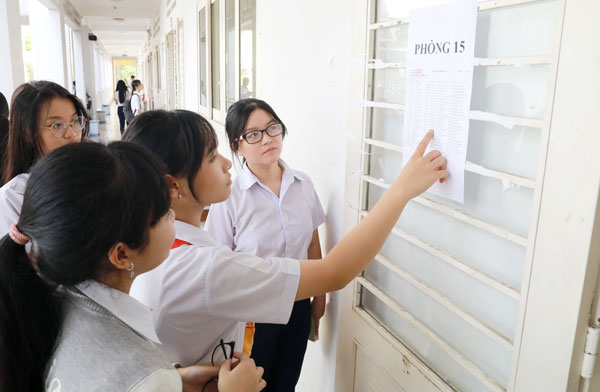 Các em học sinh kiểm tra lại danh sách thí sinh tại Hội đồng thi Trường THPT Chuyên Lương Thế Vinh. Ảnh: Huy Anh
