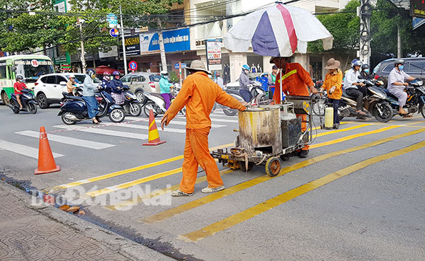 Công nhân đang tiến hành sơn mới vạch kẻ đường, gờ giảm tốc trên đường Võ Thị Sáu (TP.Biên Hòa).