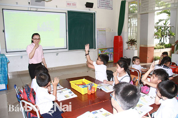 Trường tiểu học Nguyễn An Ninh (phường Tân Mai, TP.Biên Hòa) mới được công nhận trường chuẩn quốc gia. (Trong ảnh: Cô và trò Trường tiểu học Nguyễn An Ninh dạy và học với thiết bị thông minh).