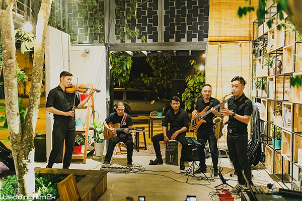 Đào Duy Tuấn (trái) biểu diễn cùng ban nhạc tại một quán cà phê ở TP.Biên Hòa