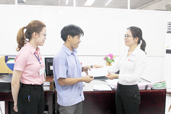 Đại diện Công ty TNHH Sản xuất đồ mộc Chien Việt Nam khen thưởng công nhân có nhiều sáng kiến, cải tiến. Ảnh: Lan Mai