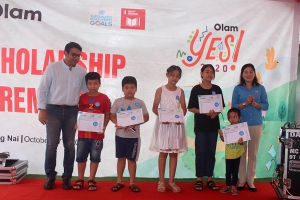 Đại diện lãnh đạo Công ty TNHH chế biến thực phẩm Olam Việt Nam và Liên đoàn Lao động H.Logn Thành trao học bổng cho con công nhân có hoàn cảnh khó khăn.