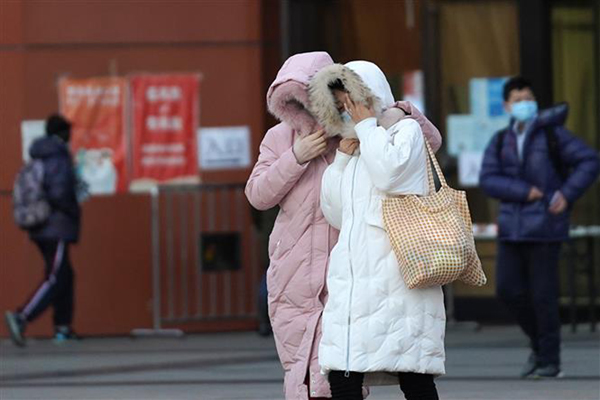 Người dân di chuyển trên đường phố trong thời tiết giá lạnh tại Bắc Kinh, Trung Quốc, ngày 29-12-2020. Ảnh: THX/TTXVN