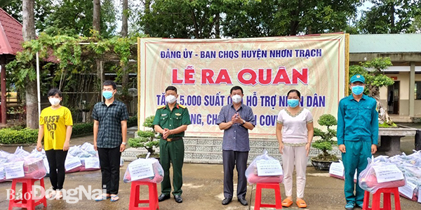 Đồng chí Lê Thành Mỹ - TUV, Bí thư Huyện ủy, Bí thư Đảng ủy Quân sự H.Nhơn Trạch trao quà cho đại diện các hộ gia đình khó khăn trên địa bàn huyện