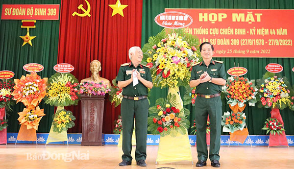 Đại tá, TS.Lê Khắc Huy, Bí thư Đảng ủy, Chính ủy Sư đoàn 309 tặng hoa chúc mừng buổi họp mặt