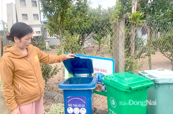 Bà Nguyễn Thị Vỹ, nông dân tại xã Phú Hòa (H.Định Quán) giới thiệu mô hình phân loại rác tại nguồn trong khu dân cư kiểu mẫu. Ảnh: B.Nguyên
