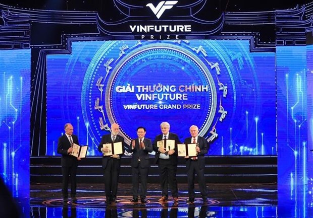 National Assembly Chairman Vuong Dinh Hue (C) presents the VinFuture Grand Prize to the laureates at the ceremony on December 20. 