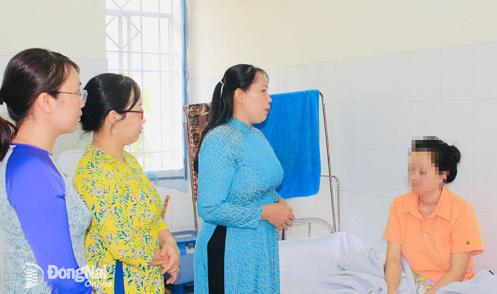 Bà Lê Thị Thái, Chủ tịch Hội LHPN tỉnh hỏi thăm tình hình sức khỏe của chị N.T.A.T. Ảnh: Nga Sơn
