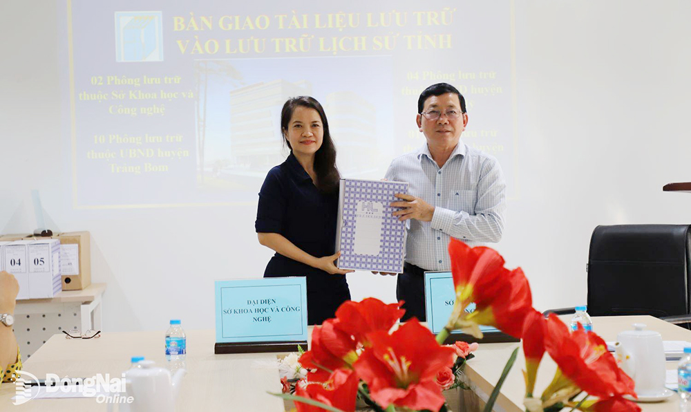 Đại diện lãnh đạo Sở Khoa học và công nghệ (bìa trái) bàn giao tài liệu lưu trữ vào Lưu trữ lịch sử tỉnh. Ảnh: My Ny