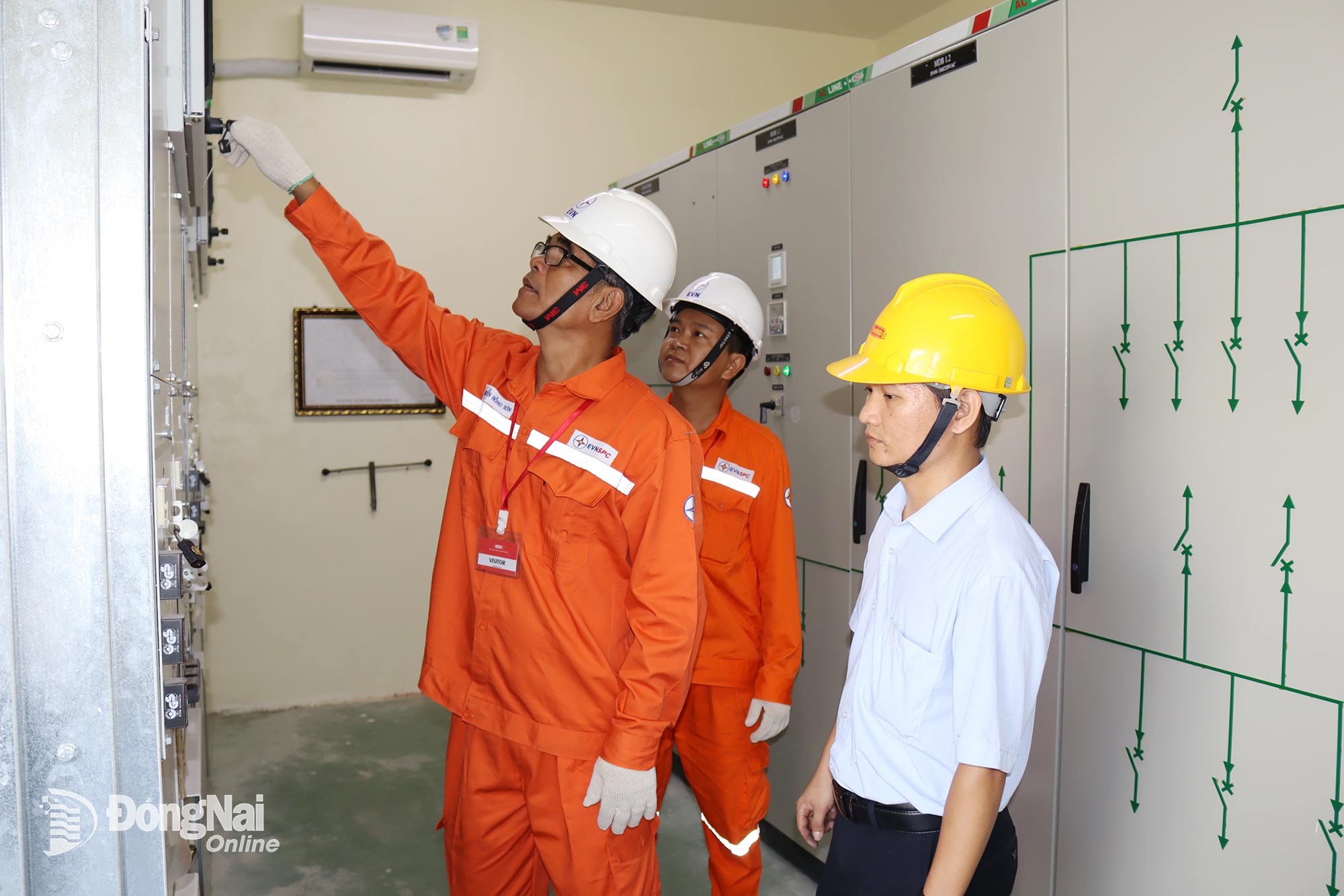 Nhân viên Công ty Điện lực Đồng Nai kiểm tra hệ thống điện tại một doanh nghiệp trong Khu công nghiệp Long Đức, xã Bình An. Ảnh: Hoàng Lộc