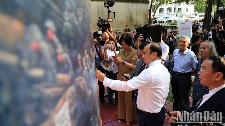 Các đại biểu trải nghiệm thực tế tăng cường tại triển lãm ảnh panorama Điện Biên Phủ.

