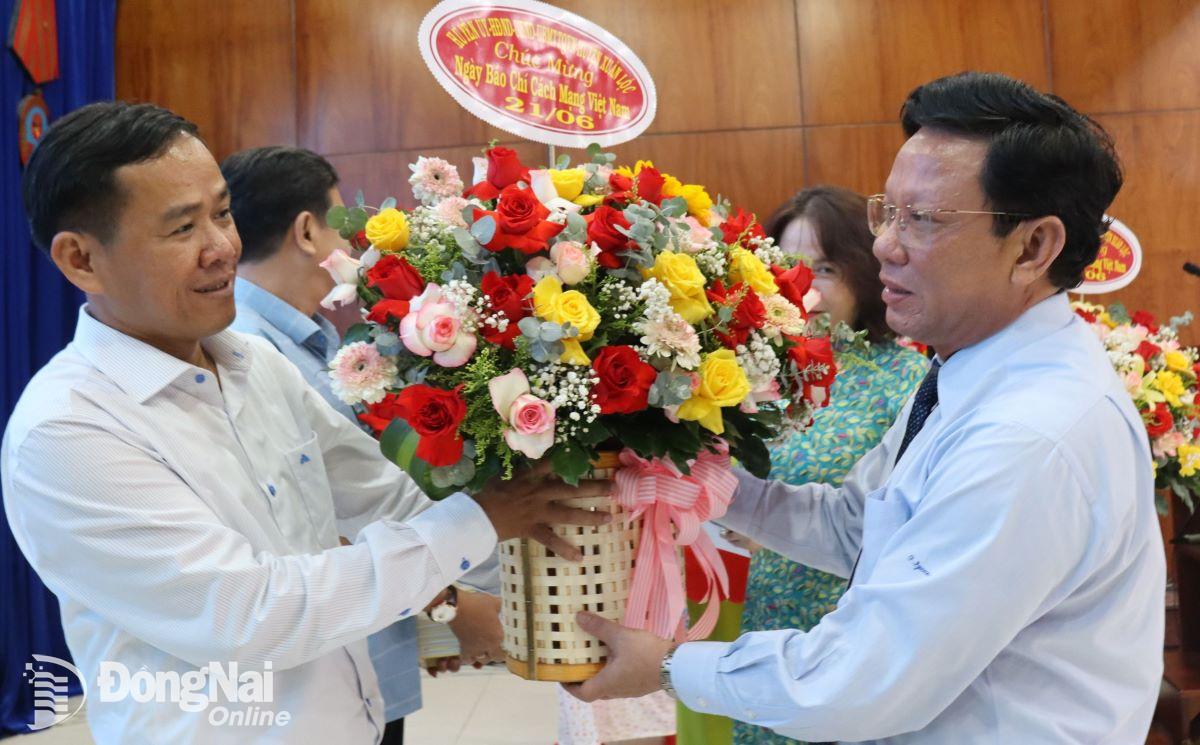 Phó bí thư thường trực Huyện ủy Xuân Lộc Nguyễn Đức Hóa tặng hoa chúc mừng các nhà báo. Ảnh: Nguyệt Hà