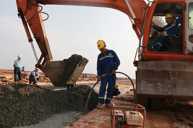 Construction workers make the Long Thanh International Airports runway. (Photo: VNA)
