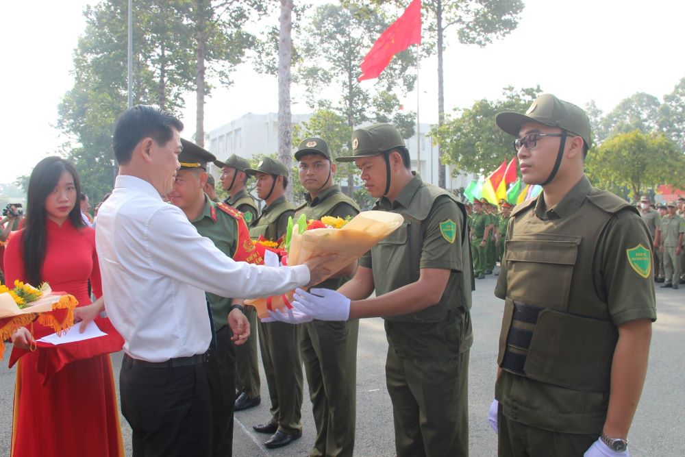 Bí thư Tỉnh ủy Nguyễn Hồng Lĩnh tặng hoa cho lực lượng tham gia bảo vệ ANTT ở cơ sở. Ảnh: Trần Danh