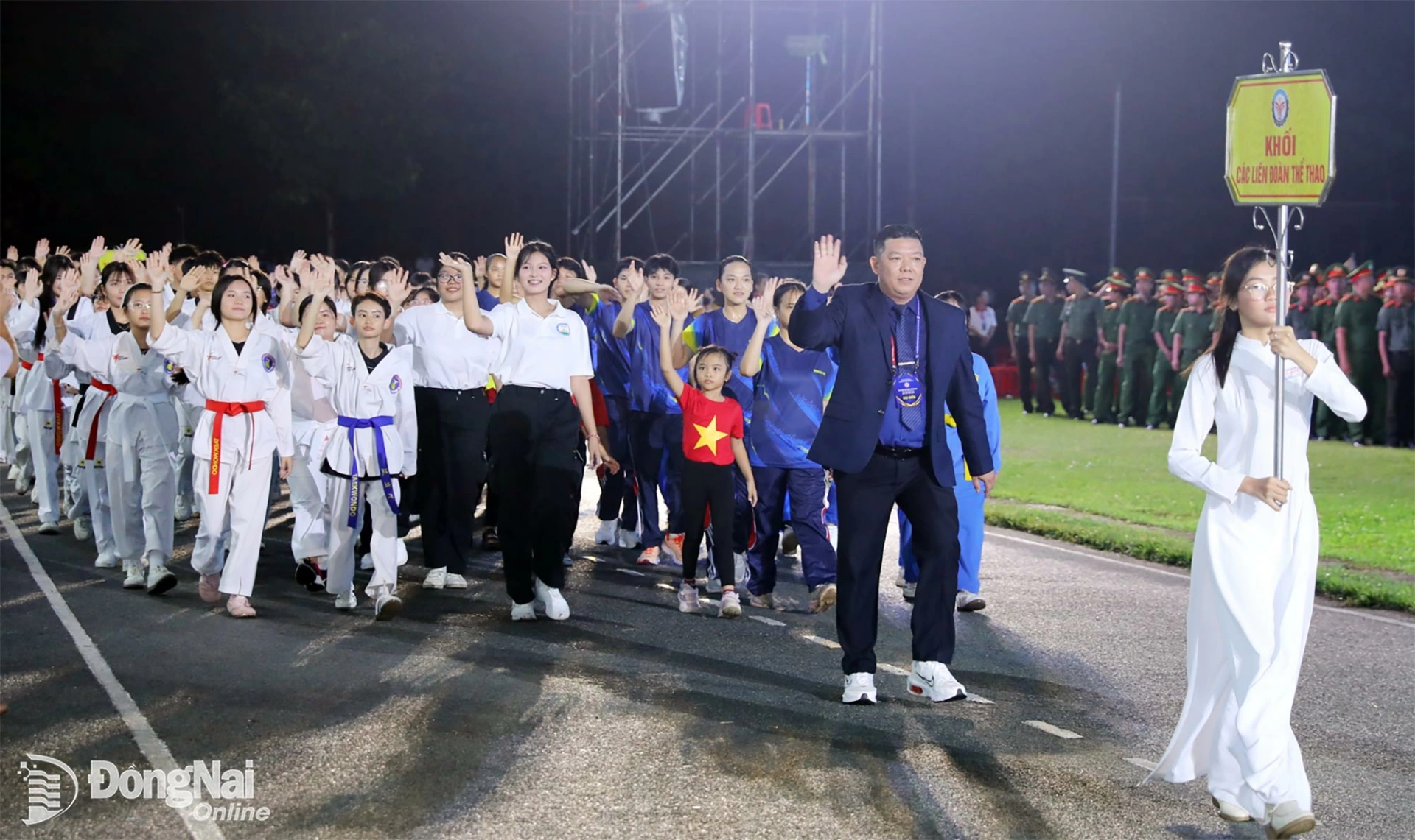 The sports delegation representing the citys 12 sports federations enters the grandstand. Photo: Huy Anh

