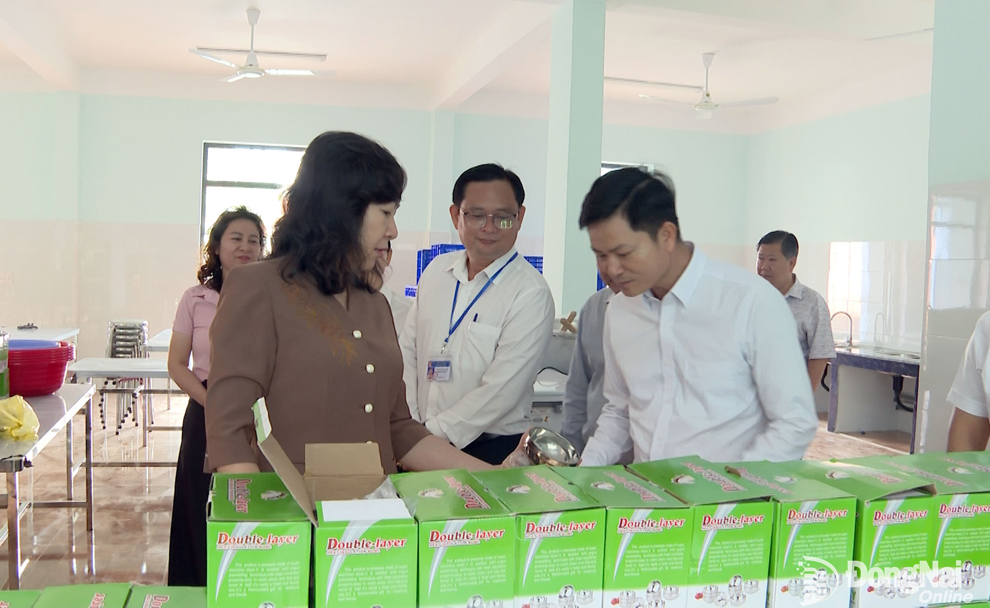 Huynh Thi Hang, Deputy Secretary of the City Party Committee and Chairwoman of the City Vietnam Fatherland Front Committee, and the delegation inspect facilities and the semi-boarding kitchen at Dak O Secondary School. Photo: Van Doan


