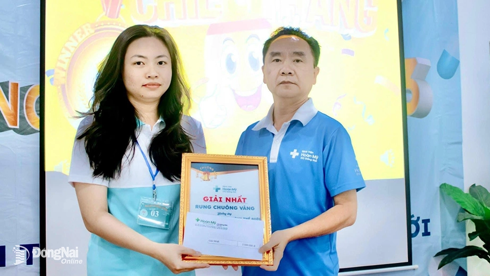 Lãnh đạo bệnh viện trao giải nhất cho kỹ thuật viên Tấn Ngọc Phương Quỳnh, khoa Xét nghiệm. Ảnh: BVCC