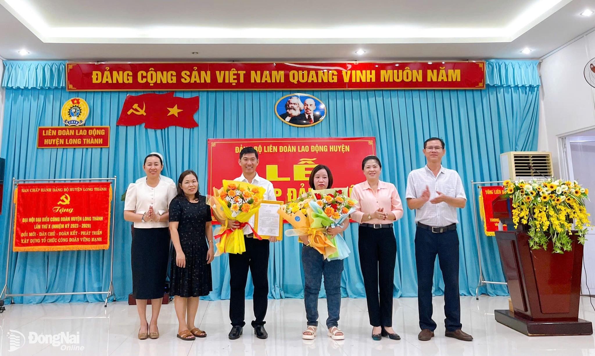 Đảng bộ Liên đoàn Lao động (LĐLĐ) huyện Long Thành  tặng hoa chúc mừng 2 đồng chí đảng viên mới vừa kết nạp. Ảnh: CĐ