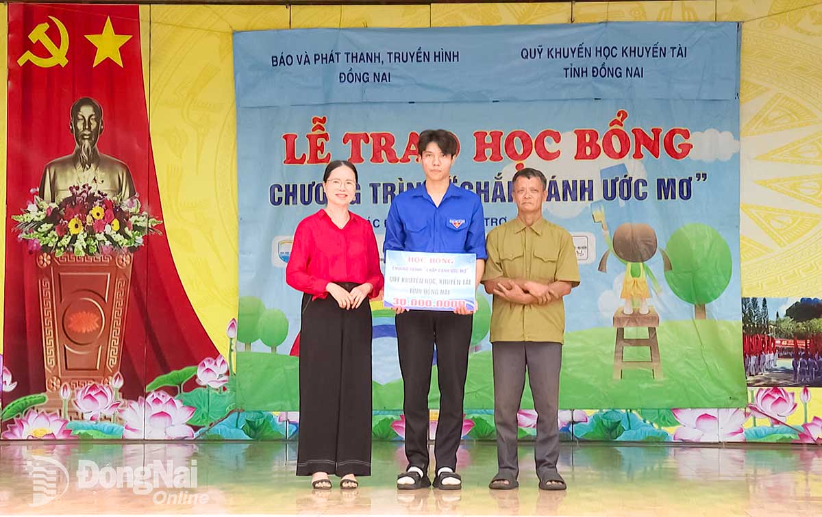 Bà Trịnh Thị Tâm, Phó Chủ tịch Hội Khuyến học tỉnh Đồng Nai trao học bổng từ Quỹ Khuyến học, trị giá 30 triệu đồng. Ảnh: Phú Quý
