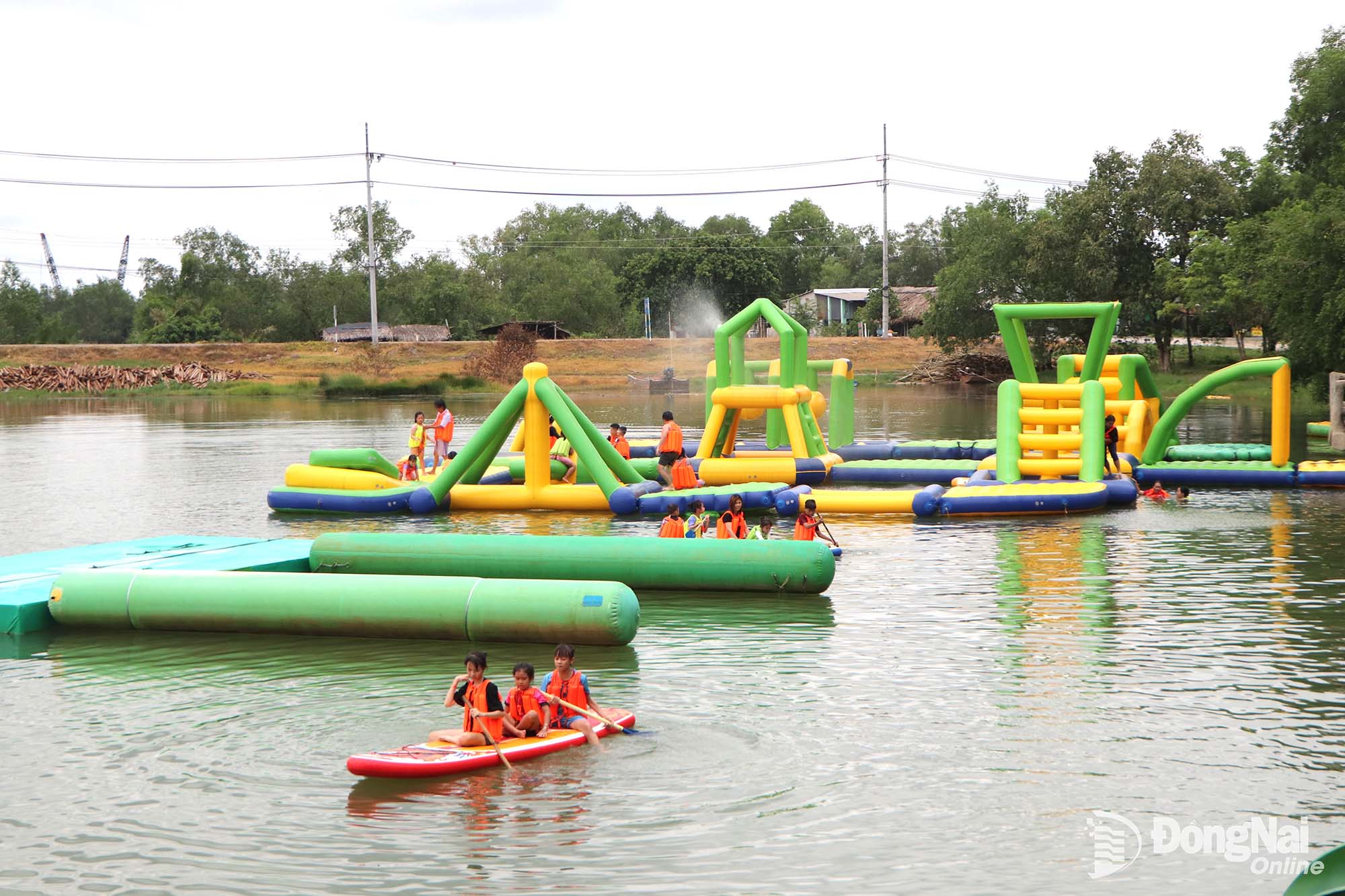 Tourists enjoy river bathing and water-based activities at Bo Cap Vang Ecotourism Area in Dai Phuoc Commune.