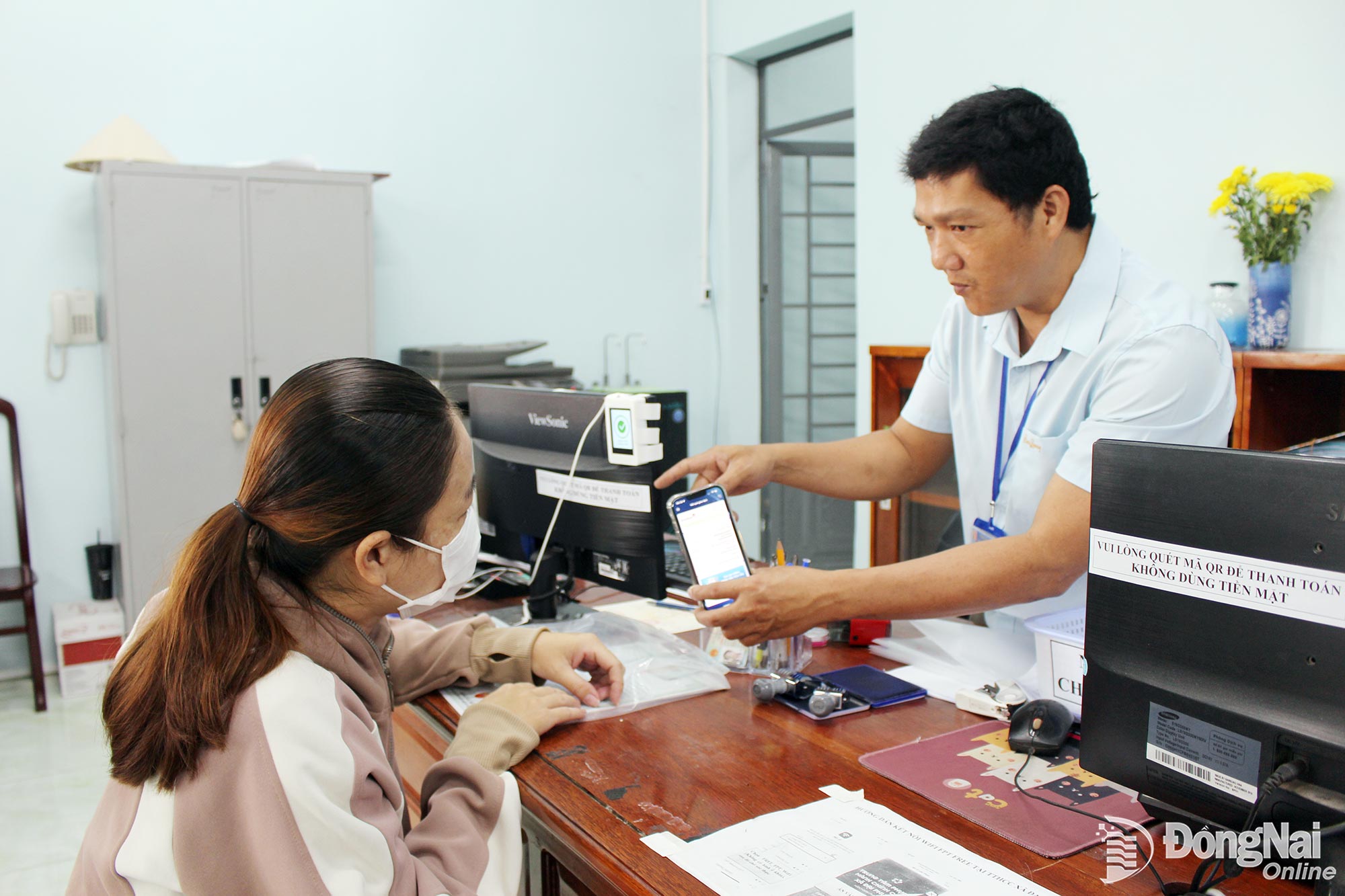 Residents receive guidance from officials at the Dai Phuoc Commune Public Administration Service Center on completing administrative procedures online.


