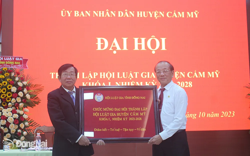 Chủ tịch Hội Luật gia tỉnh Phan Văn Châu (phải) chúc mừng luật gia Nguyễn Văn Lễ, Chủ tịch Hội Luật gia H.Cẩm Mỹ 