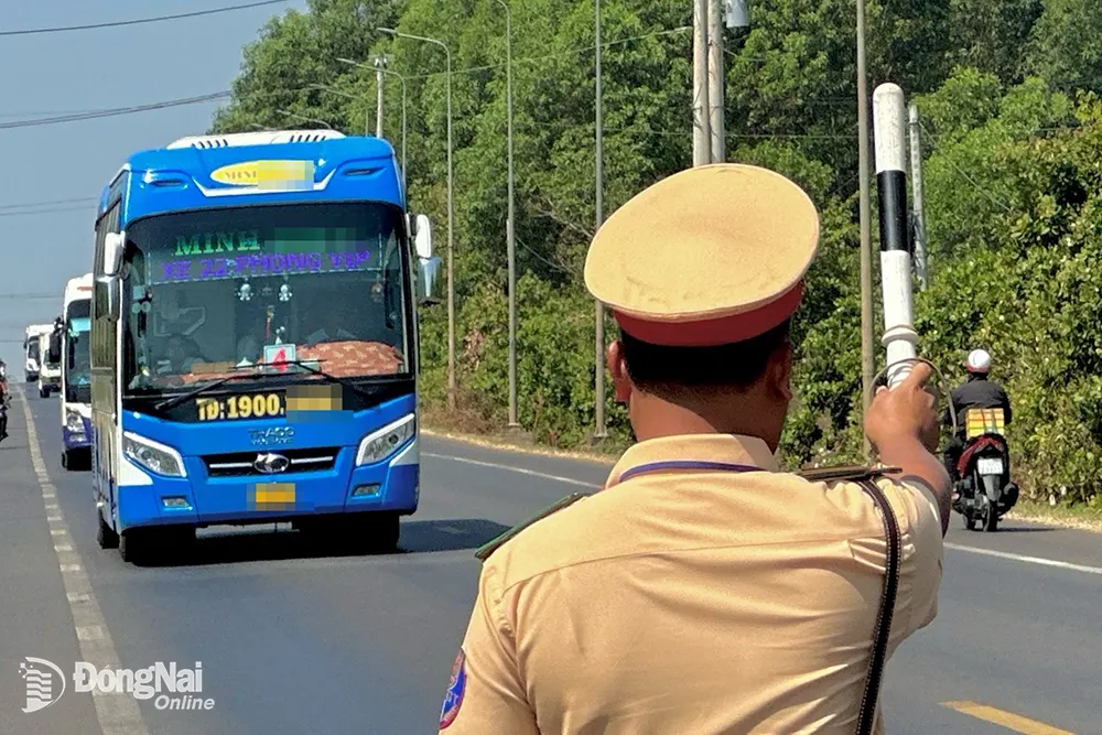 Lực lượng cảnh sát giao thông kiểm soát xe khách di chuyển trên quốc lộ 20 (H.Định Quán) Ảnh: Minh Thành