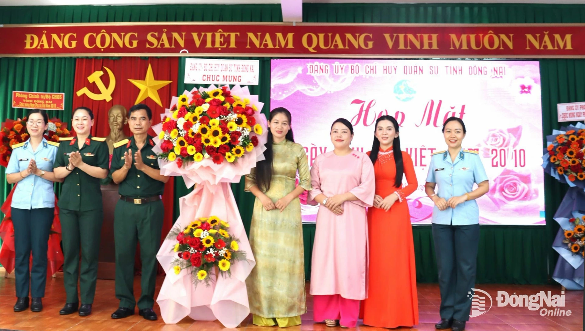 Đại tá Bùi Văn Sỹ, Ủy viên Thường vụ Đảng ủy, Phó Chính ủy Bộ Chỉ huy Quân sự tỉnh tặng hoa cho Hội Phụ nữ cơ quan Bộ Chỉ huy Quân sự tỉnh Đồng Nai tại buổi họp mặt. Ảnh: Nam Anh