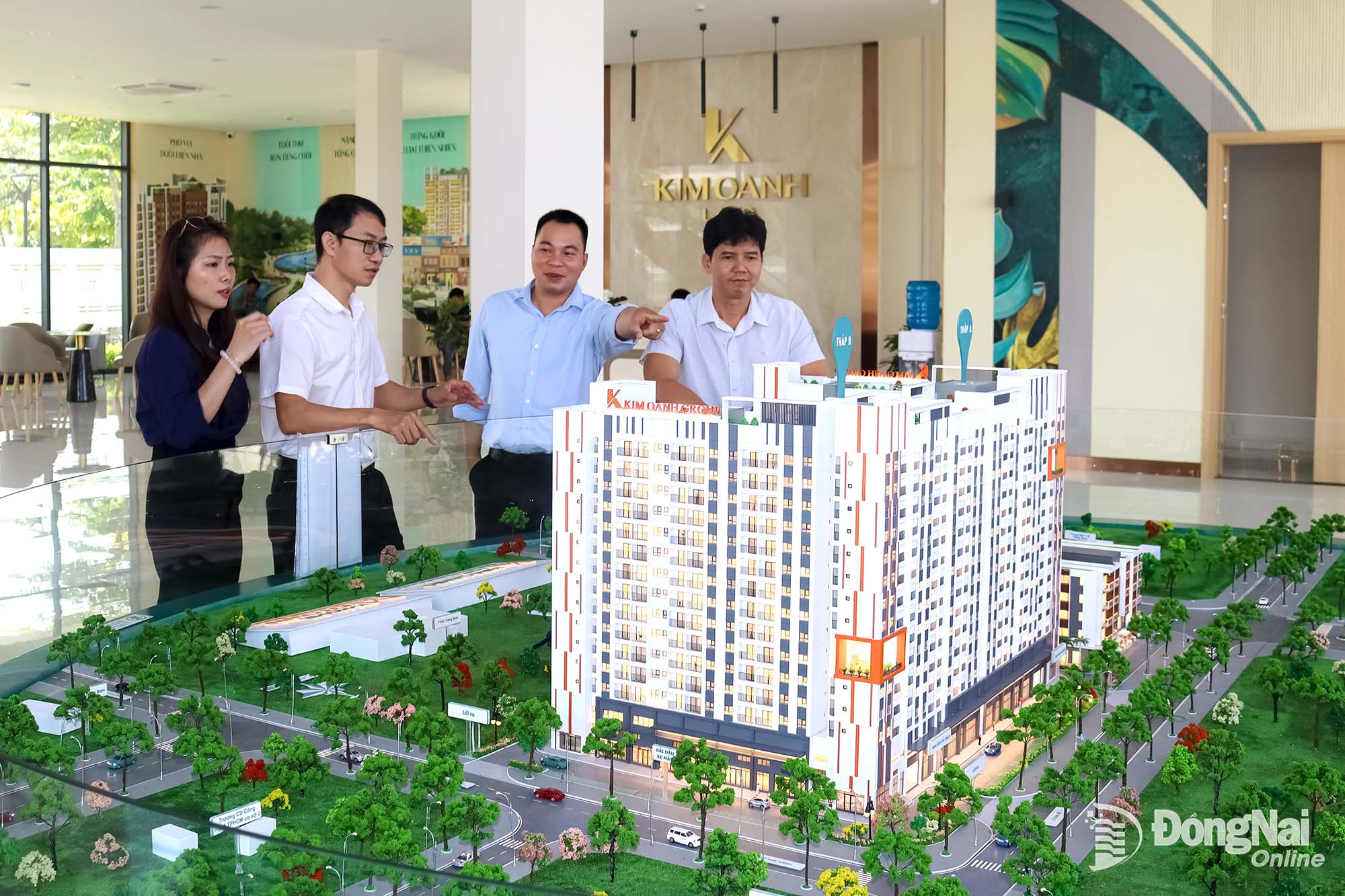 Customers learn about a social housing project through a scale model in Trang Bom ward. Photo: Hoang Loc


