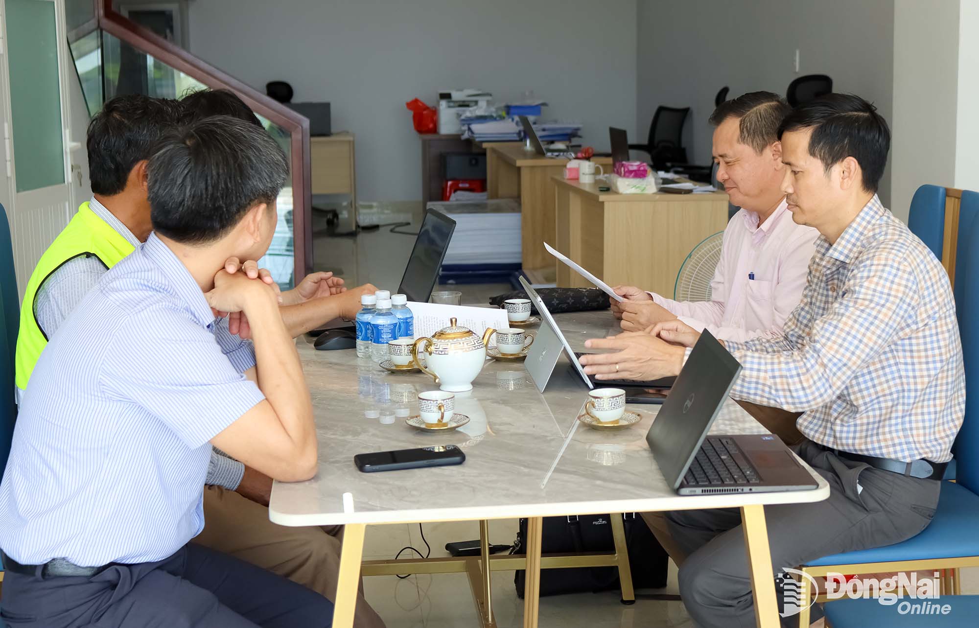 Representatives of the DoC work with the developer of a social housing project in Trang Bom Ward. Photo: Hoang Loc


