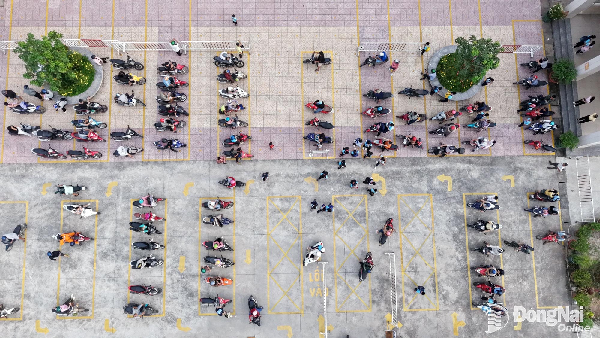 Parents park their motorbikes neatly inside the school grounds in accordance with the instructions. Photo: Cong Nghia

