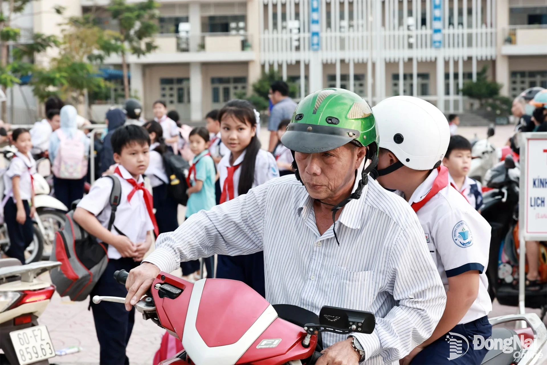 Both parents and students wear helmets when riding motorbikes. Photo: Cong Nghia

