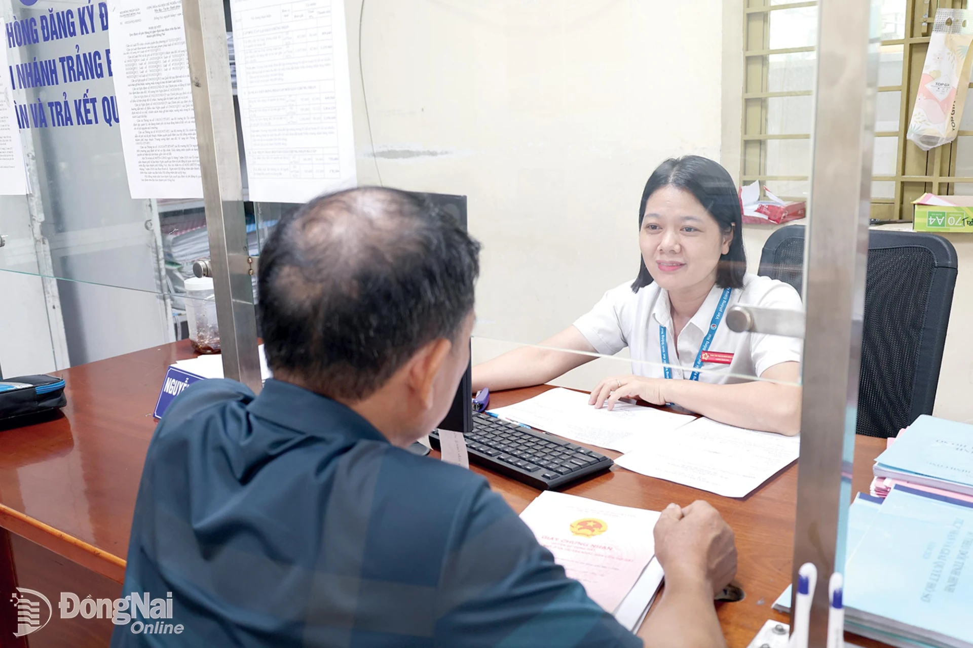 Staff at Trang Bom ward’s PASC handle administrative procedures for residents.